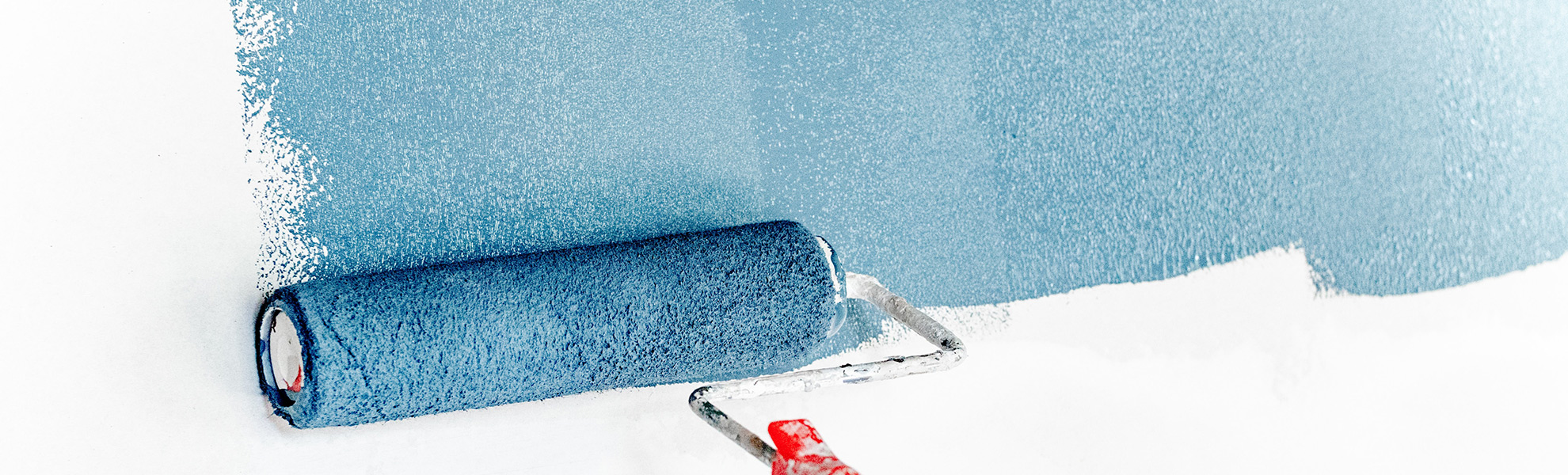 Applying Blue Paint on Wall with Roller blue paint, wall painting, professional painting services, skilled painter