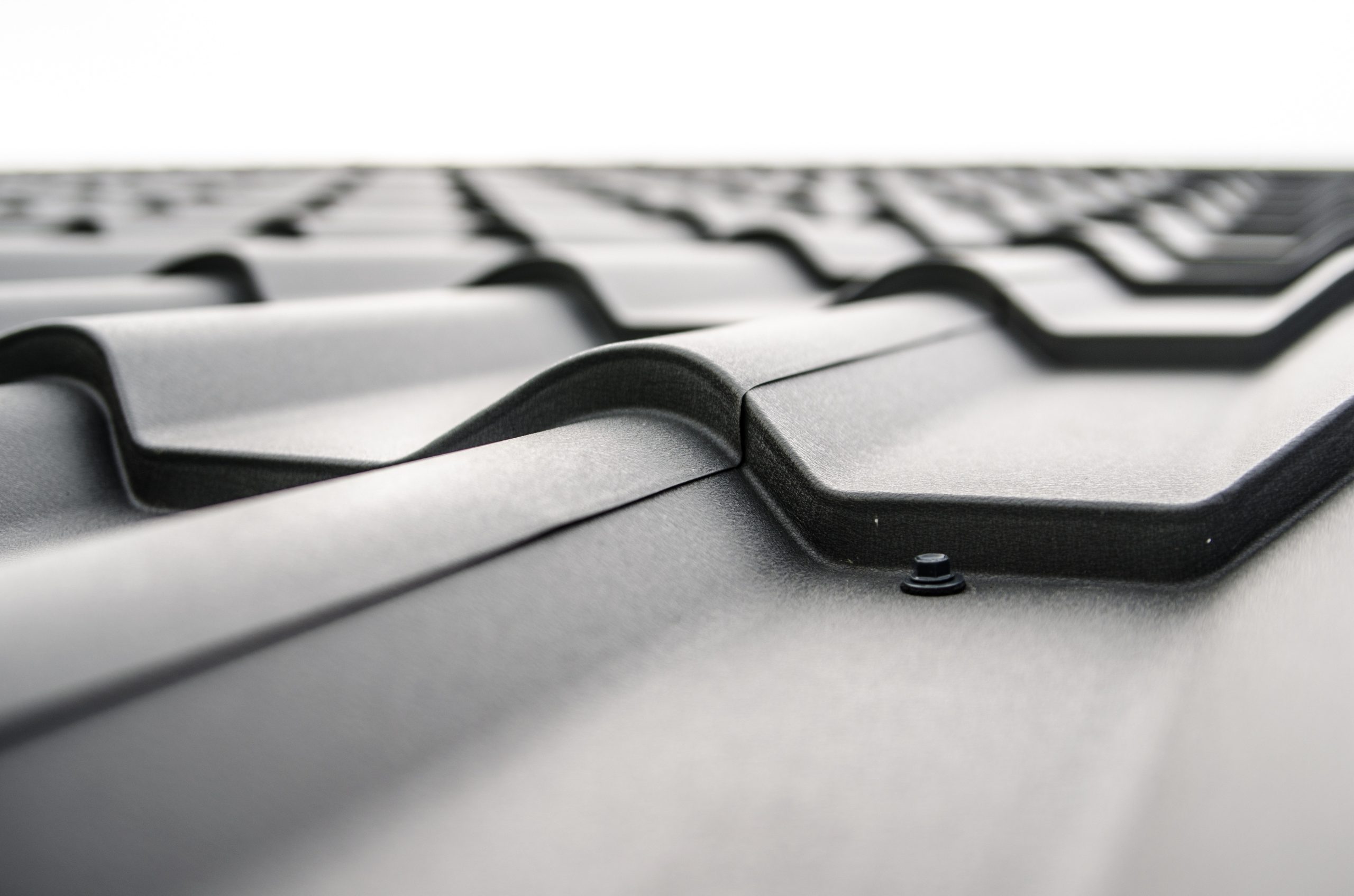 Professional roofing contractor installing asphalt and metal roofs